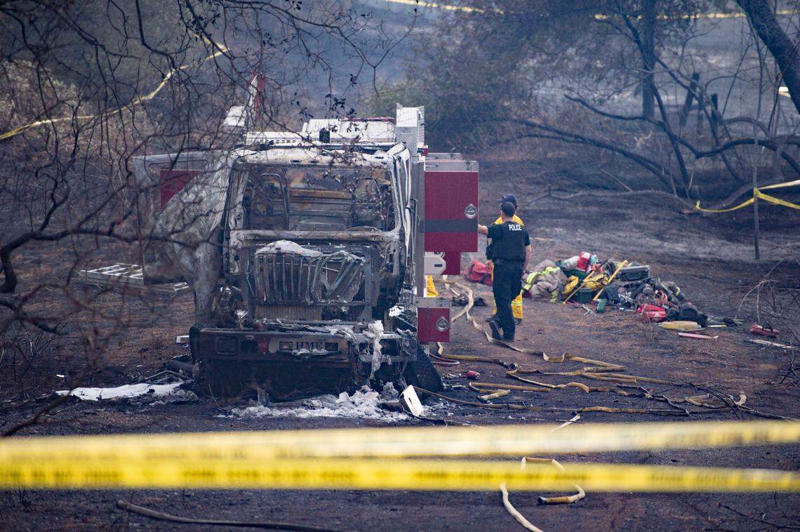 Crews look over the fire engine that Capt. Chris Schwegler and firefighter Scott Wagner had to abandon during the Country Fire in El Dorado County on Sept. 3.