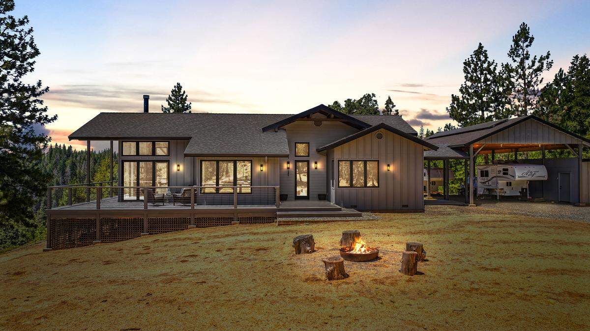 The modern, off-grid residence, sitting on 232 acres, offers sweeping forest views through large windows