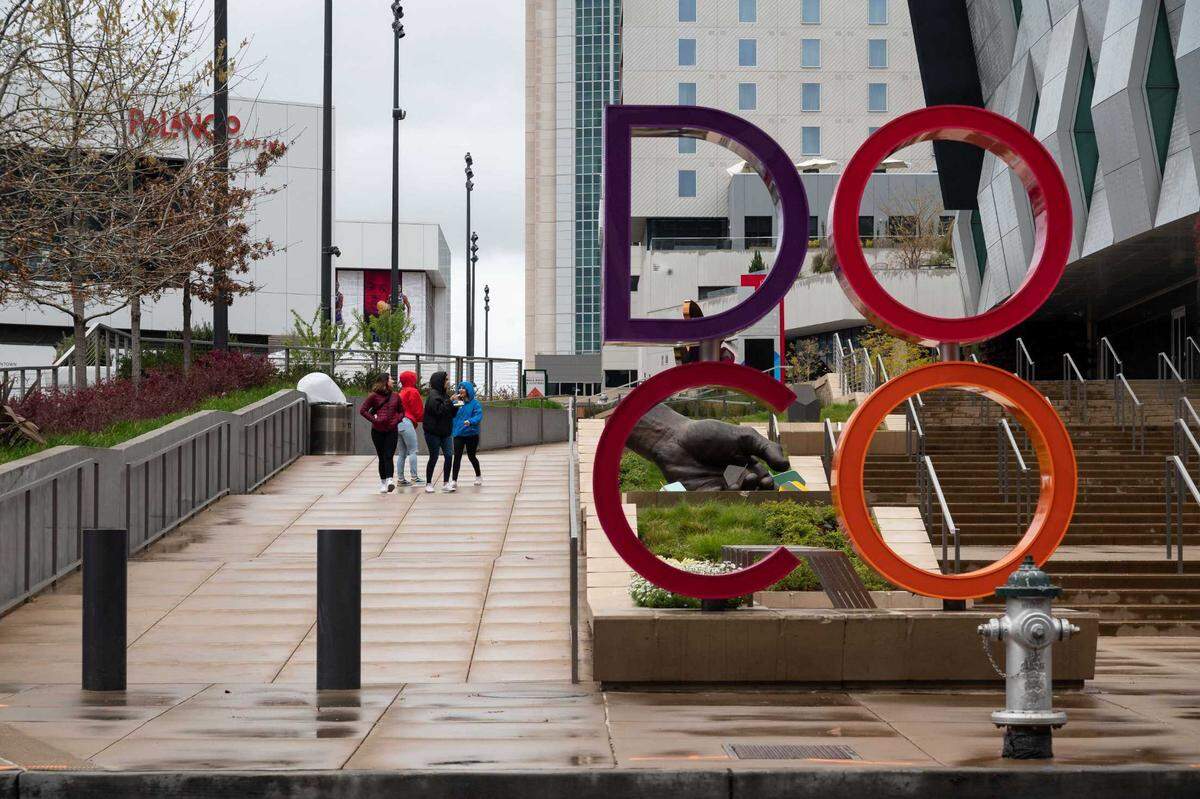 People walk through Downtown Commons on March 14, 2020, in Sacramento.