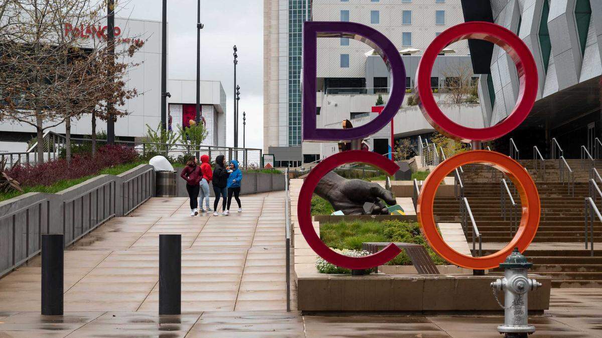 People are seen walking through Downtown Commons on March 14, 2020, in Sacramento. The Northern California dessert business Cakes by Jeff the Chef will open its permanent location in May in DoCo.