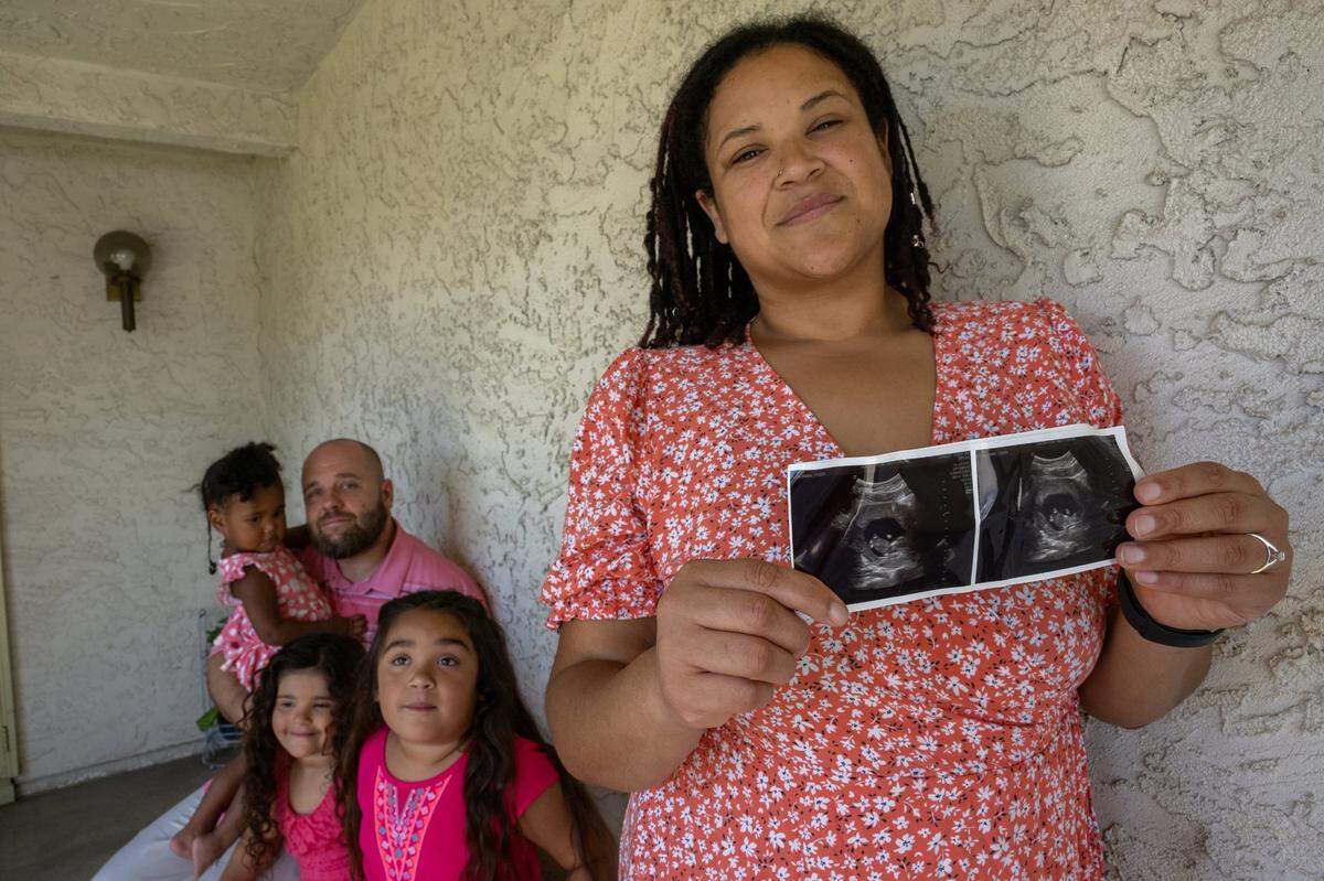 Destinee Campbell holds a sonogram of her baby, who is due in February, while standing with her family in Rio Linda earlier this month. “I’m a little bit nervous because I’m having some high blood pressure spikes so that means I’m probably going to end up in the hospital and I’m nervous they are going to push a cesarean instead of allowing me just to VBAC with this baby,” said Campbell.