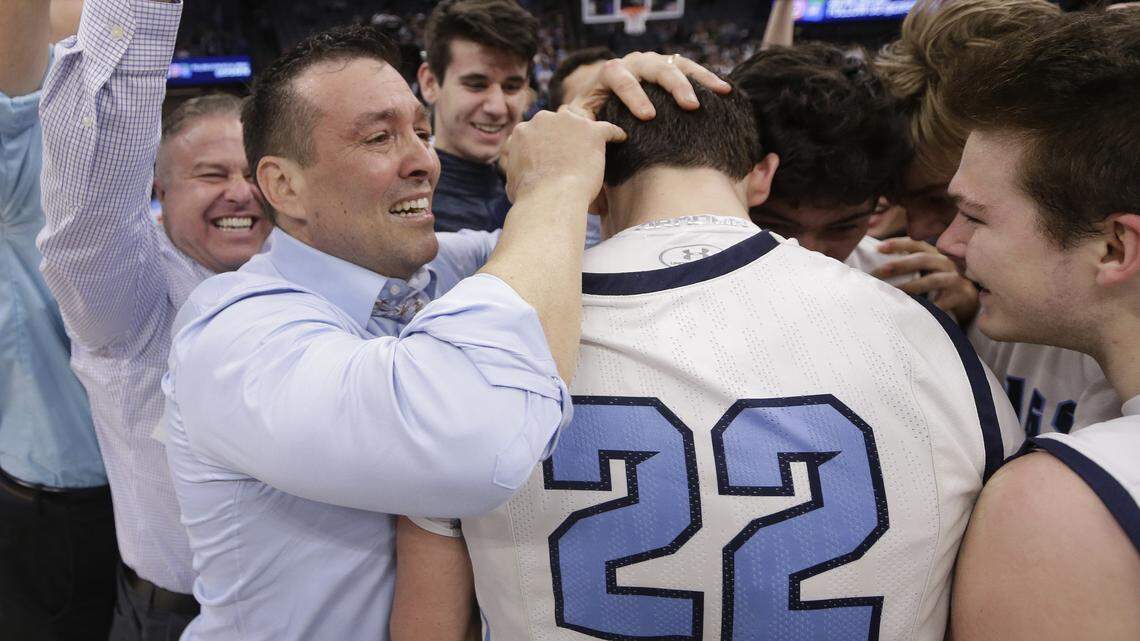 Pleasant Valley head coach Tim Keating hugs Kevin Kremer, right, while celebrating their 70-65 win over Notre Dame High School in the boy's Division III high school championship basketball game Saturday, March 24, 2018, in Sacramento, Calif.
