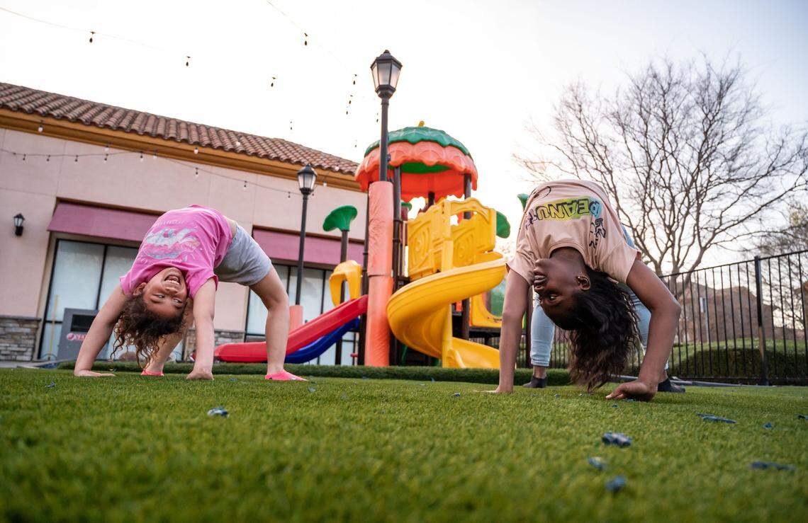 Layla Jefferson, left, 7, and Kamera Bell, 11, play together outside Willie J’s Burgers & More in North Natomas on March 16 after their parents got together for a meeting of the Natomas Black Parents United group. 