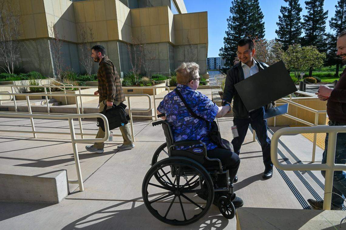 Evan Underwood, center, returns his Department of General Services computer equipment on March 8 after he quit his job because he could no longer work remotely full-time.