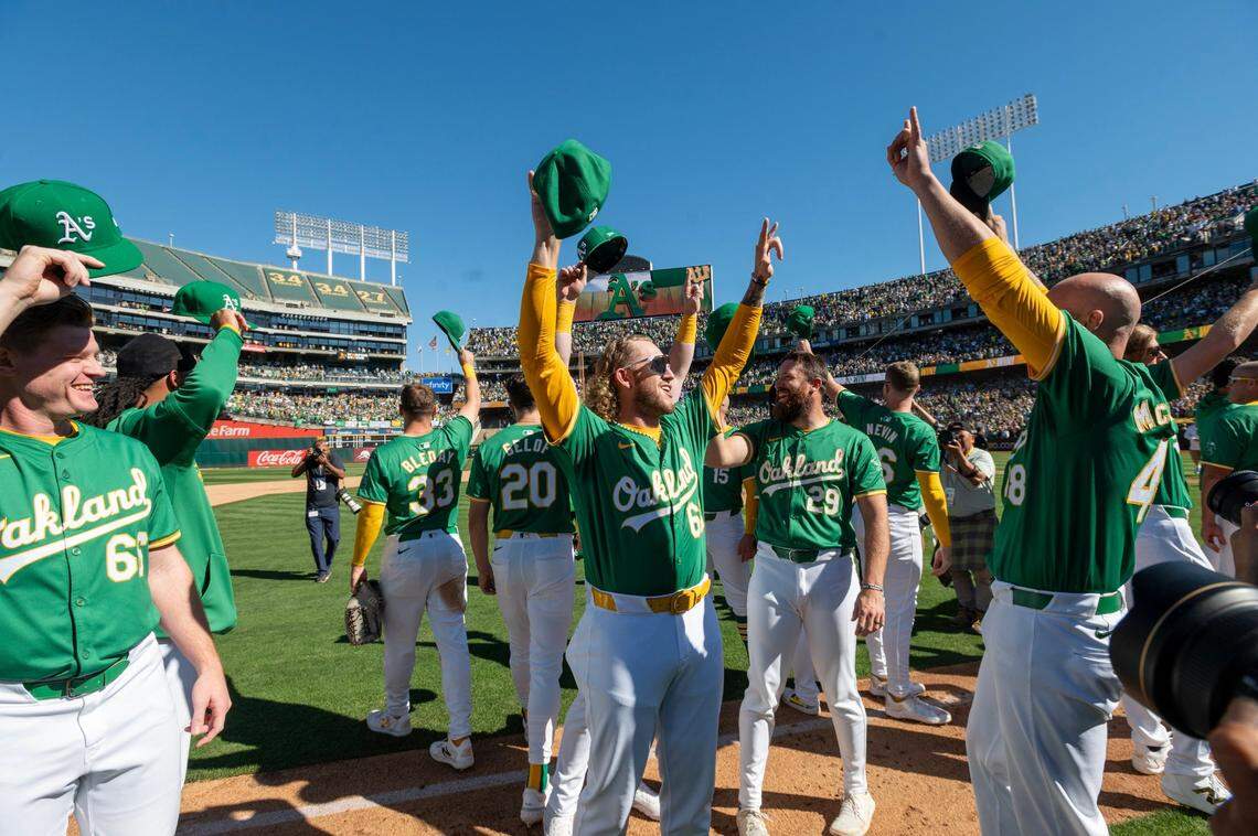 The Oakland A’s cheer after winning the last home game against the Texas Ranger at Oakland-Alameda County Coliseum on Thursday.
