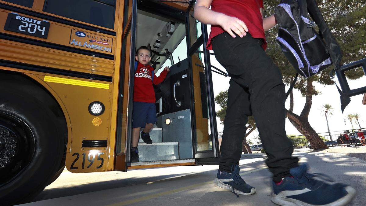 Students step off the school bus as they arrive for classes at San Marcos Elementary School Friday, May 4, 2018, in Chandler, Ariz., after a statewide teachers strike ended.