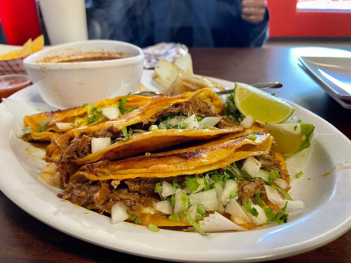 Cocina Doña Chuyita makes quesabirria tacos, pictured here with consommé.