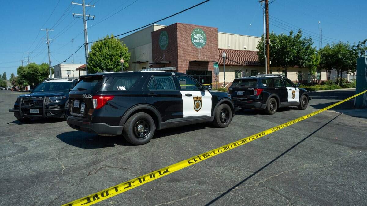 Sacramento Police vehicles are parked in front of homeless service provider Loaves & Fishes, which was closed during the investigation of the death of a homeless person, on Tuesday.
