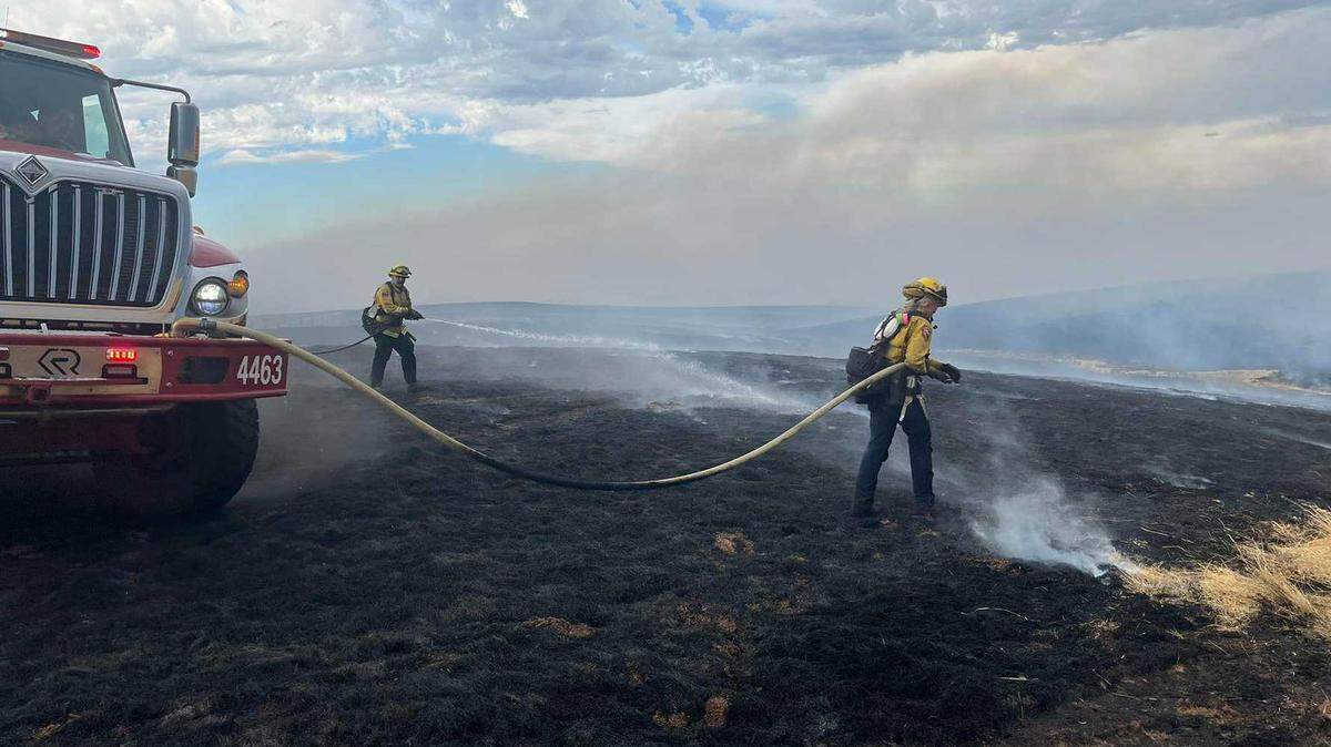 Firefighters douse flames on one of several wildfires that sparked Tuesday, Sept. 2, 2025, in Tuolumne and Calaveras counties. The union representing state firefighters is pushing for a new retirement benefit for older members.