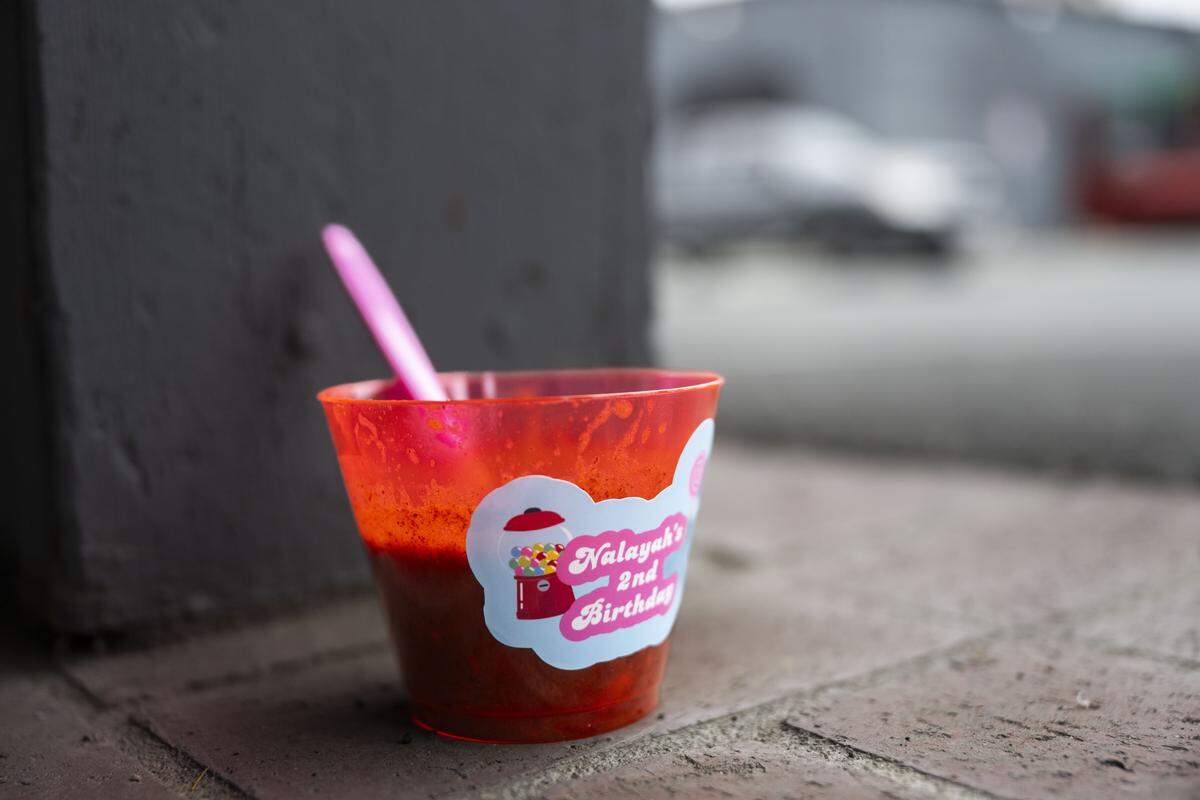 A cup labelled “Nalayah’s 2nd Birthday” sits Monday at the Lucile Avenue building just outside the Stockton city limits where 15 people were hit by gunfire in a mass shooting over the weekend.
