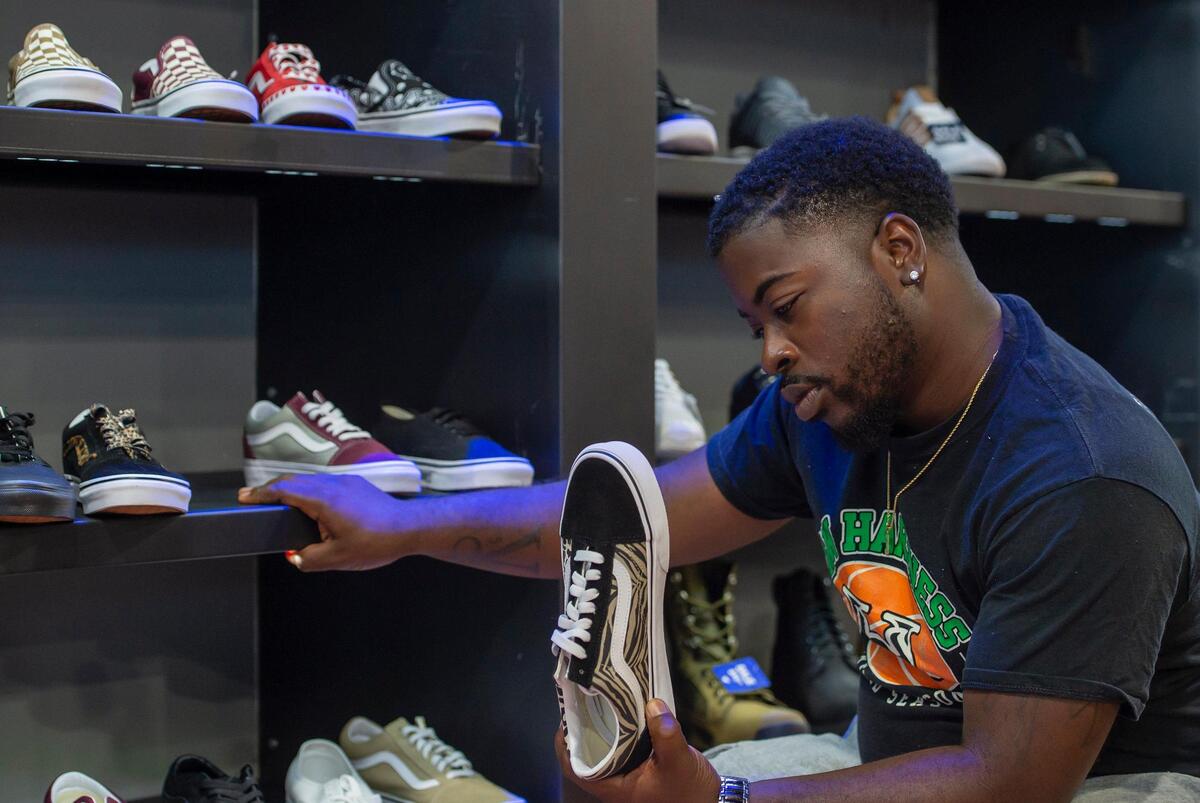 Tyler McClure, 28, shops for shoes at Sheikh in Sacramento on Wednesday, July 21, 2021, for the Voice of the Youth’s first shoe drive happening Sunday from 11 a.m. to 3 p.m. at Hidden Gems Thrift Store.