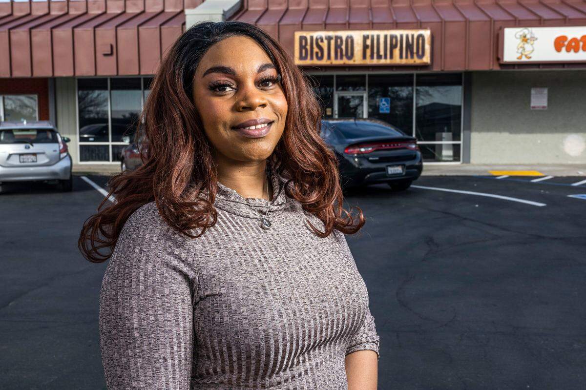 La Krisha Young stands in January in front of storefront that she is renting for her dispensary business in south Sacramento.