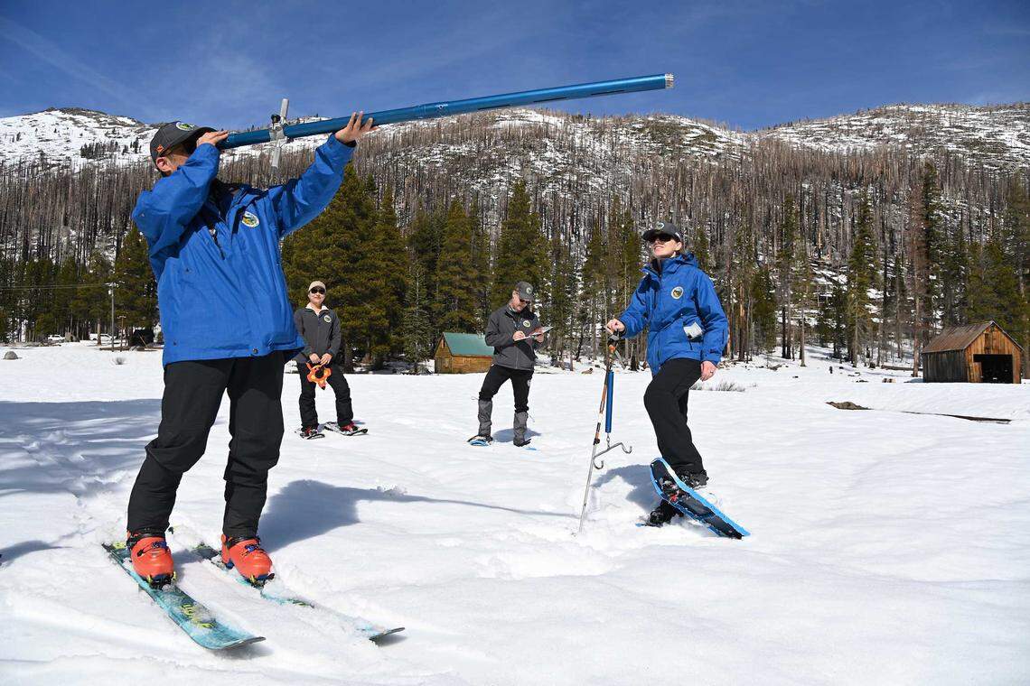 From left, Department of Water Resources staffers Derick Louie, Angelique Fabbiani-Leon, Andy Riesing and Jordan Thoennes conduct the third media snow survey of the season at Phillips Station on Friday, Feb. 27, 2026. The measurement showed statewide snowpack at 66% of average for this date as officials monitor water supplies ahead of the April 1 peak.