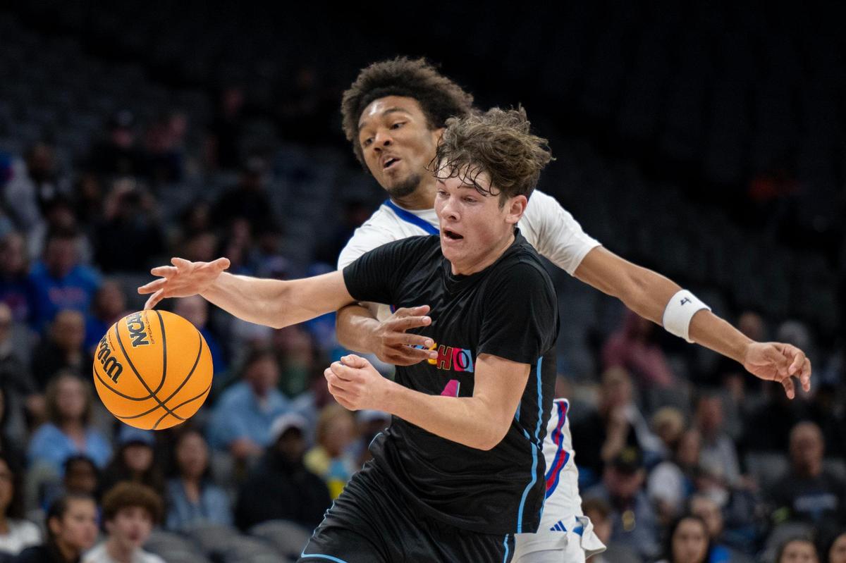 The Christian Brothers Falcons’ Stephan Hewitt (13) reaches around the El Capitan Gauchos’ Guerin Bliss (4) to knock the ball away in the first half of the CIF Sac-Joaquin Section Championship Division III championship on Friday, Feb. 28, 2025, at Golden 1 Center.