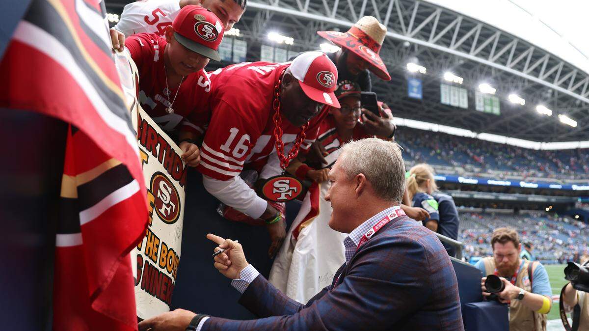 SEATTLE, WASHINGTON - SEPTEMBER 07: General manager John Lynch of the San Francisco 49ers signs autographs after defeating the Seattle Seahawks during the game at Lumen Field on September 07, 2025 in Seattle, Washington. (Photo by Amanda Loman/Getty Images)