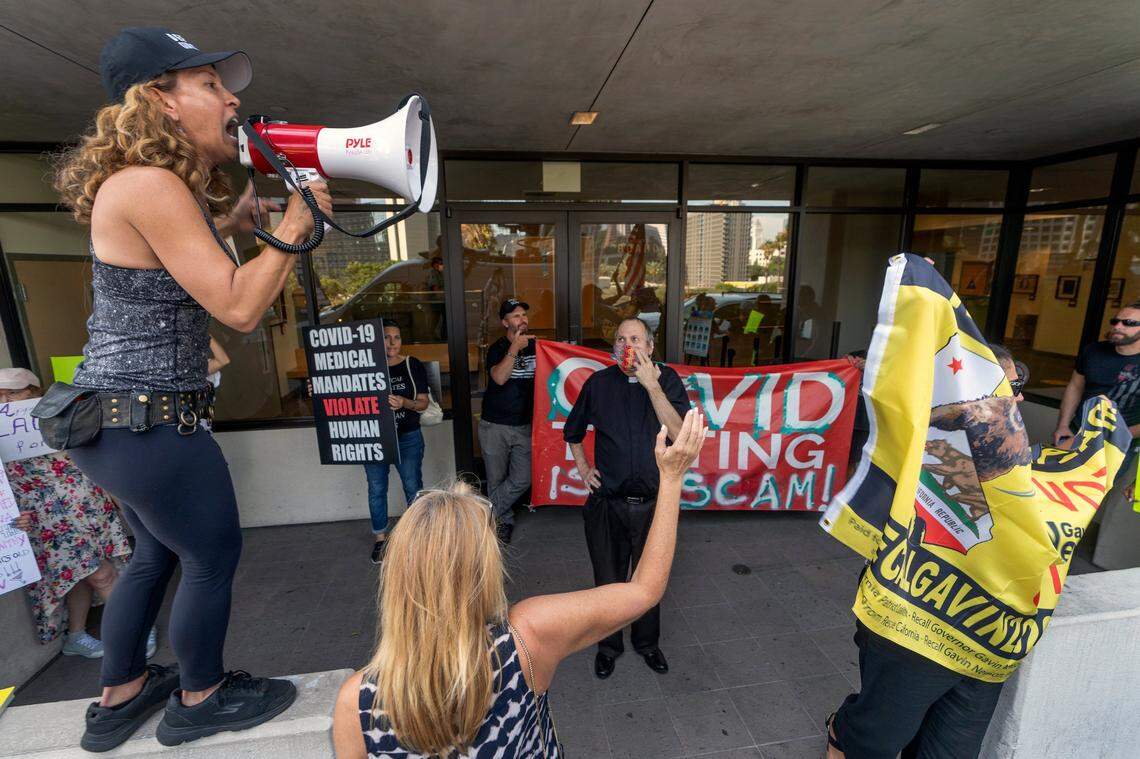 Anti-vaccine mandate protesters and supporters of the California recall election rally outside the front doors of the Los Angeles Unified School District headquarters in September after the county board of education voted Thursday to require students 12 and older to be vaccinated against the coronavirus to attend in-person classes.