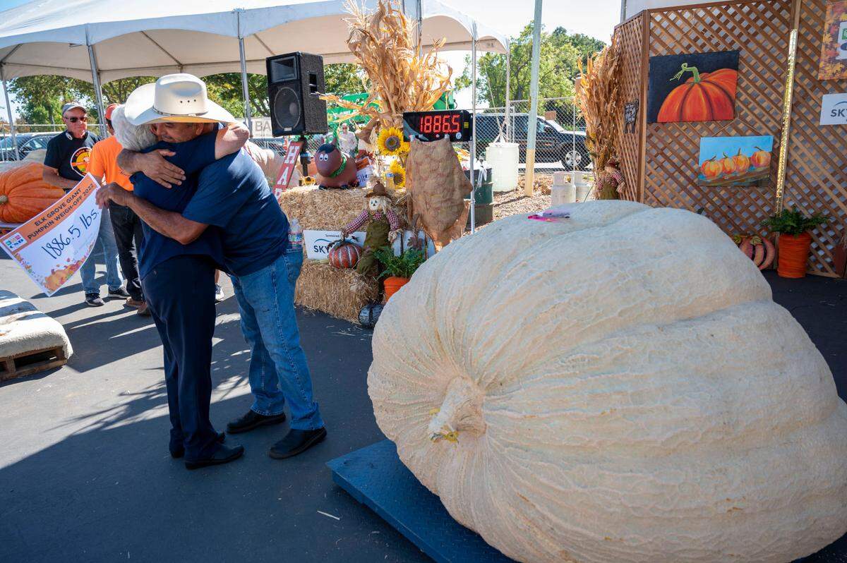 Napa County grower Jose Ceja gets a big hug from his mom, Carmen Barragan, after winning the giant pumpkin contest Saturday, Oct. 1, 2022, at the annual Elk Grove Giant Pumpkin Festival. His pumpkin weighed in at 1,886 pounds, earning him $7,000.