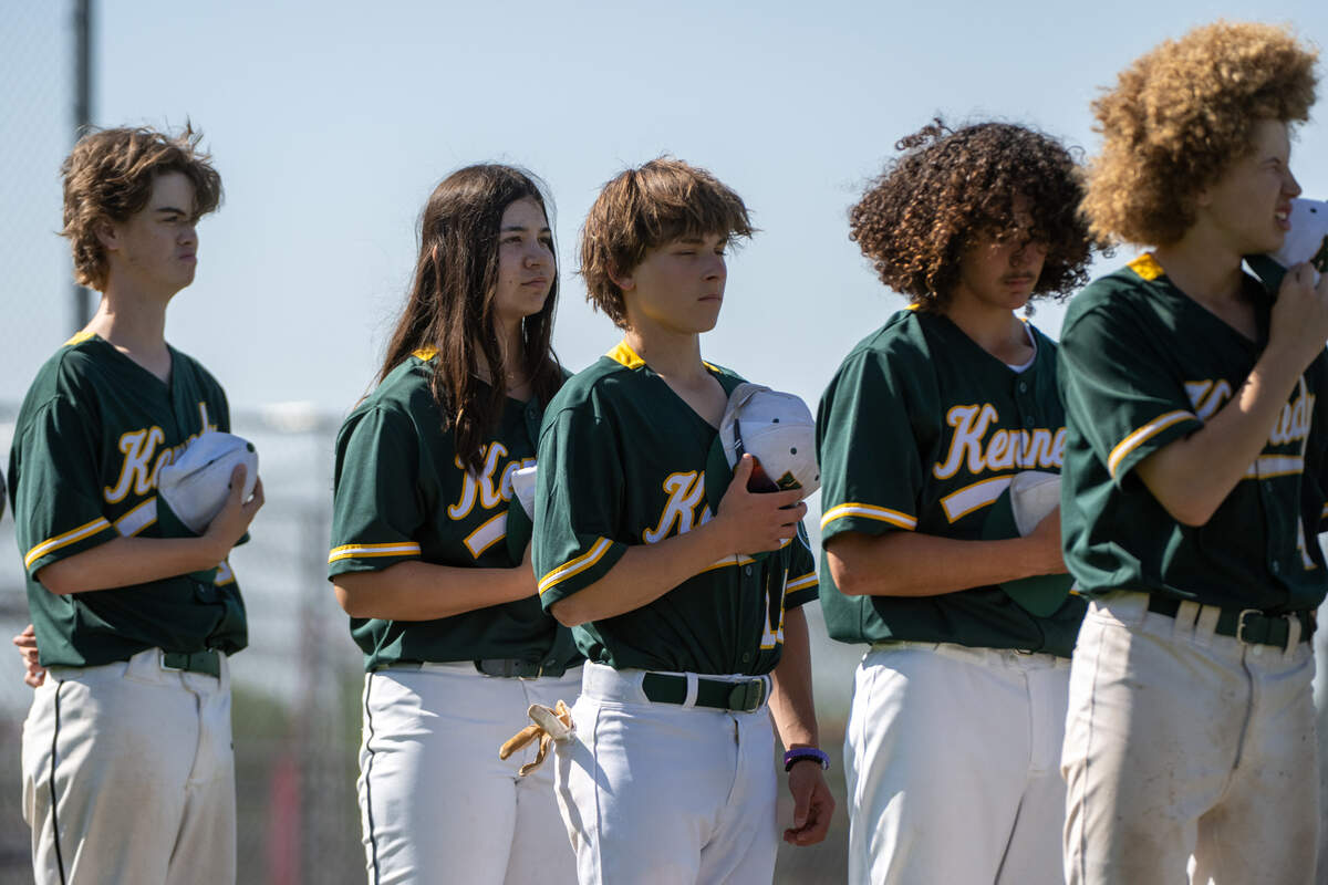 The Kennedy Cougars’ Laney Fukuoka stands with her teammates during the national anthem before the game against the Antelope Titans on Monday in Antelope. Fukuoka, a team captain, pitches and plays first base on the varsity baseball team.