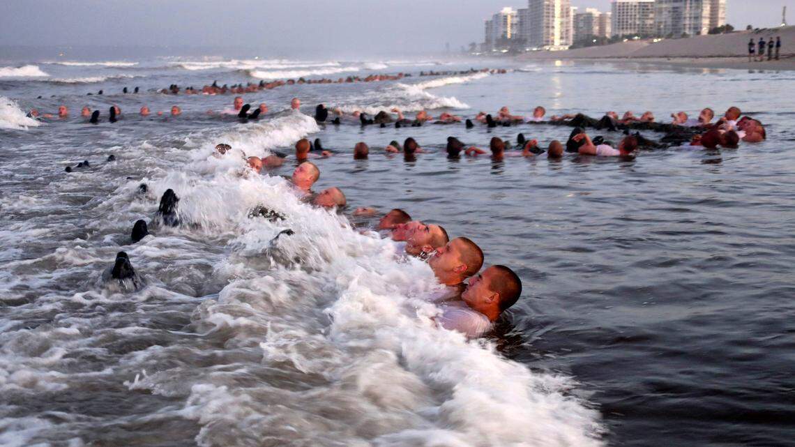 SEAL candidates participate in “surf immersion” during Basic Underwater Demolition/SEAL (BUD/S) training at the Naval Special Warfare Center in Coronado, Calif., in May.