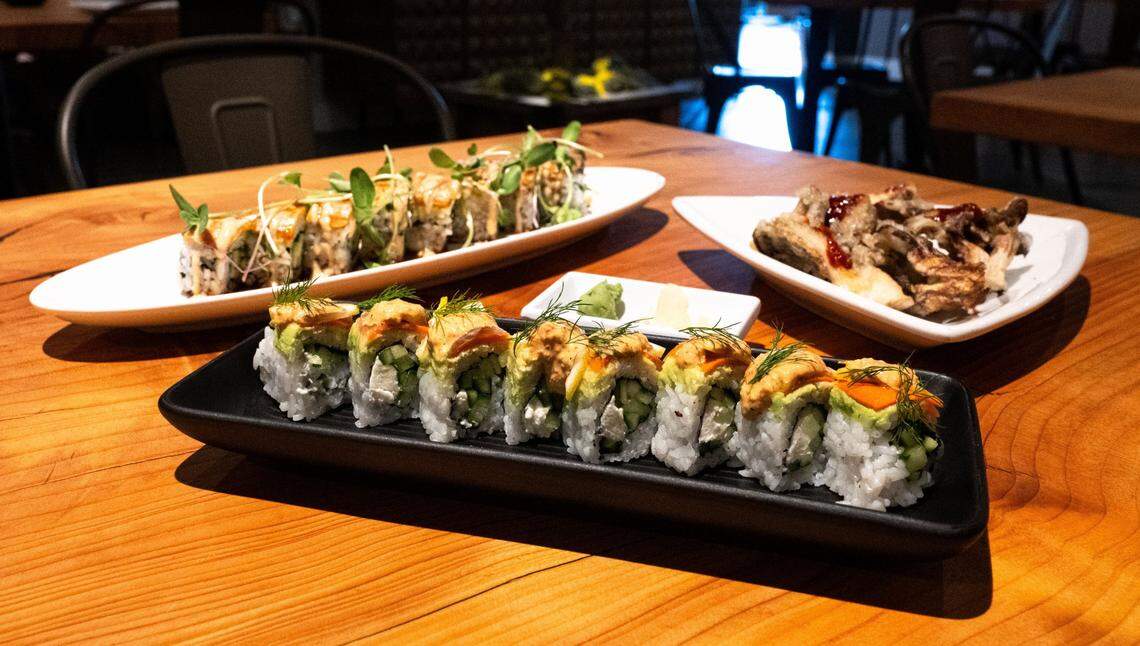 The smokey vale roll, center, featuring vegan cream cheese and topped with smoked carrots, lemon and a chipotle aioli at Village of OM Plant Kitchen in Sacramento on July 1, 2025.