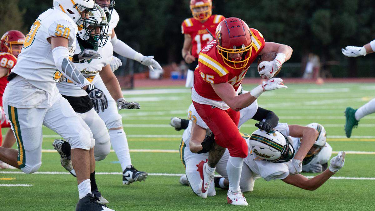 The Jesuit Marauders’ Alan Cordano (25) dives into the end zone against the Rio Americano Raiders on Friday at Jesuit High School in Carmichael. 