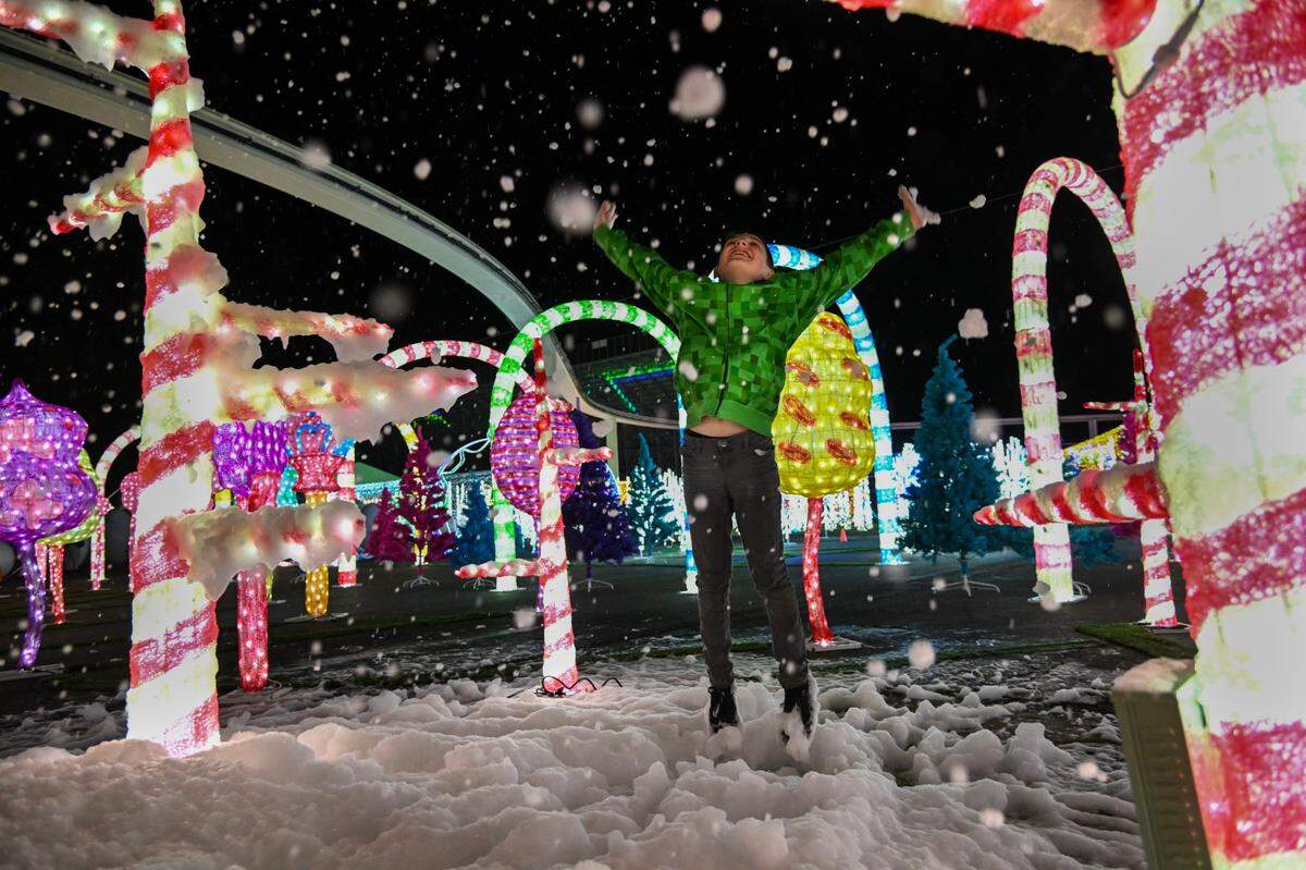 Joshua Tejada, 8, of Redding, plays in bubbles floating in the air near the candy cane display at the Imaginarium at the Cal Expo in Sacramento in 2022. 