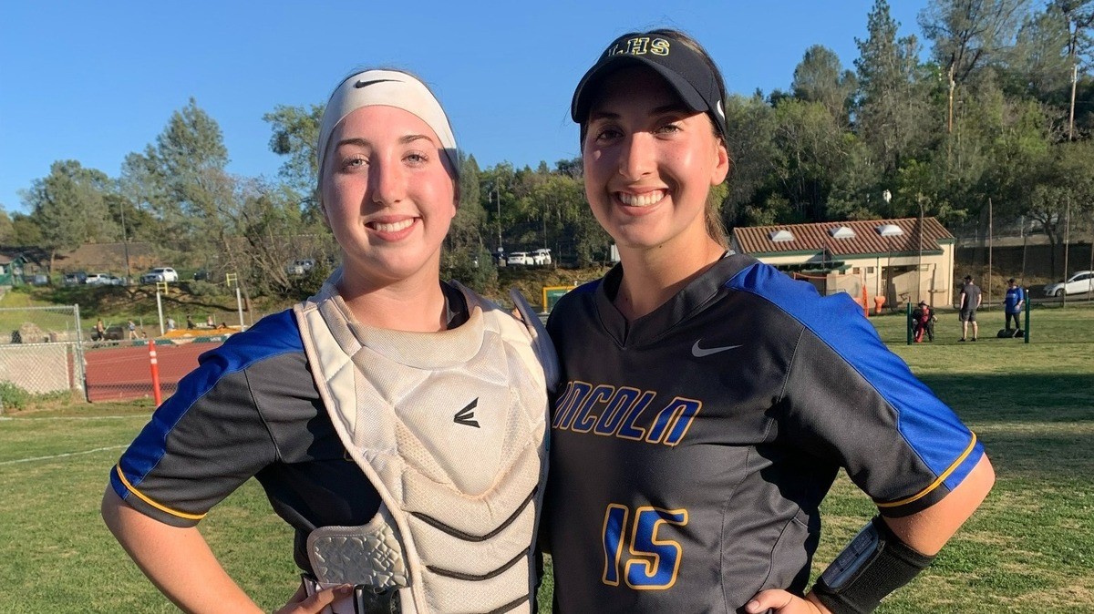 Gianna Domenici calls the pitches for twin sister Ava at Lincoln High School.