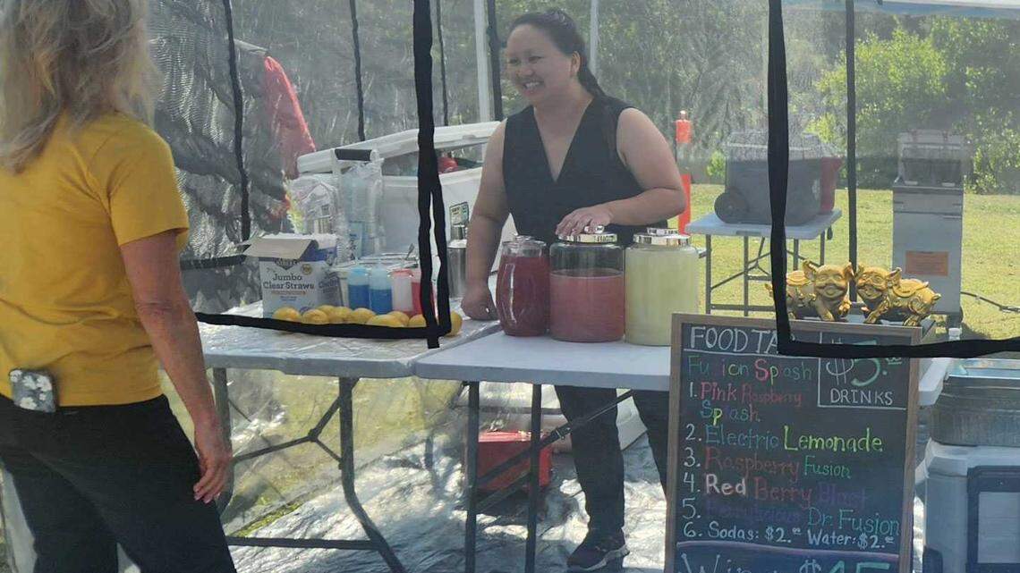 Vendor Food Tap serves lemonade "fusion splashes" as well as wings and fries at the West Sacramento Farmers Market on Jun. 17, 2025.