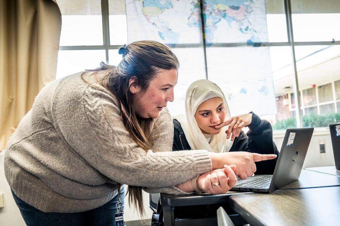 Kimberly Miller, a history teacher at Starr King TK-8, helps seventh-grader Marjan Amini with an assignment earlier this month.