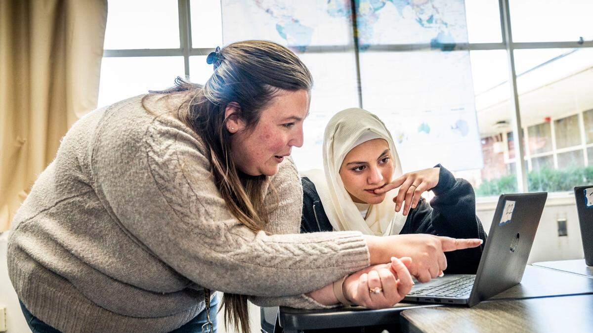 Kimberly Miller, a history teacher at Starr King TK-8, helps seventh-grader Marjan Amini with an assignment Wednesday, Feb. 15, 2023.