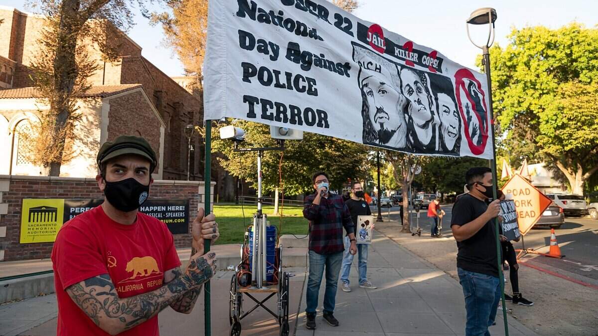 Members of the Sacramento Area Peace Action, Answer Coalition and NorCal Resist stage a rally in Sacramento on Thursday, Oct. 22, 2020, as part of the 25th annual National Day Against Police Terror. It was one of three simultaneous demonstrations held in the downtown area by different groups. “We’re highlighting the different aspects of police terror that are occurring here in the city and abroad as well,” said protester Steven Sander.