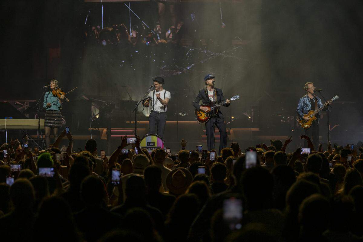 Wesley Schultz, lead singer, center left, is joined by members of The Lumineers as they perform “Flowers In Your Hair” at Golden 1 Center in downtown Sacramento on Wednesday.