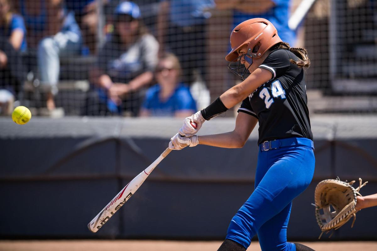 Capital Christian Cougars batter Brianna Johnson (24) hits a sacrifice fly ball during the seventh inning against the Dixon Rams at the CIF Sac-Joaquin Section Division IV high school softball championship game Saturday, May 27, 2023, at Cosumnes River College.