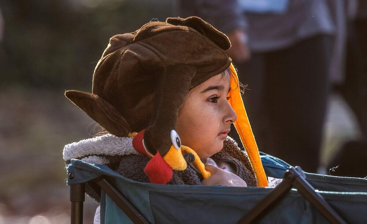 Asa Randhawa, 4, of Sacramento takes a ride in a wagon on J Street during the 30th annual Run to Feed the Hungry on Thursday in East Sacramento.