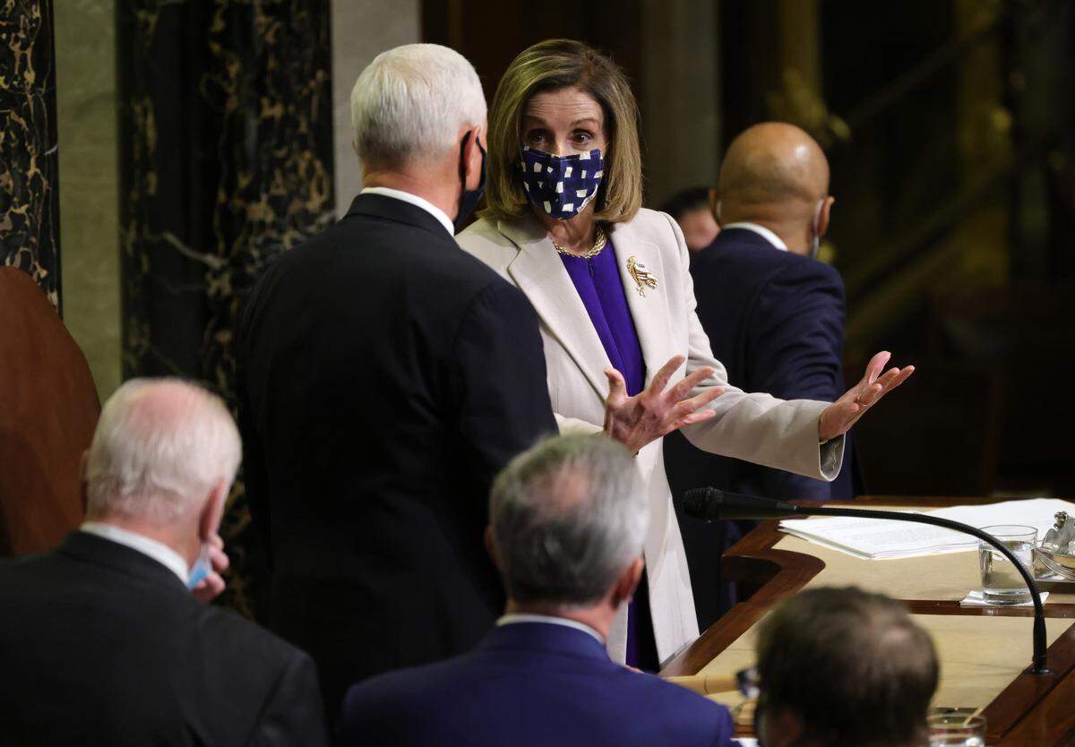 Speaker of the House Speaker Nancy Pelosi, D-Calif., talks with Vice President Mike Pence after the conclusion of the count of electoral votes during a reconvening of a joint session of Congress on Jan. 7, 2021 in Washington, D.C. Members of Congress returned to the House Chamber after being evacuated when protesters stormed the Capitol and disrupted a joint session to ratify President-elect Joe Biden's 306-232 Electoral College win over President Donald Trump.