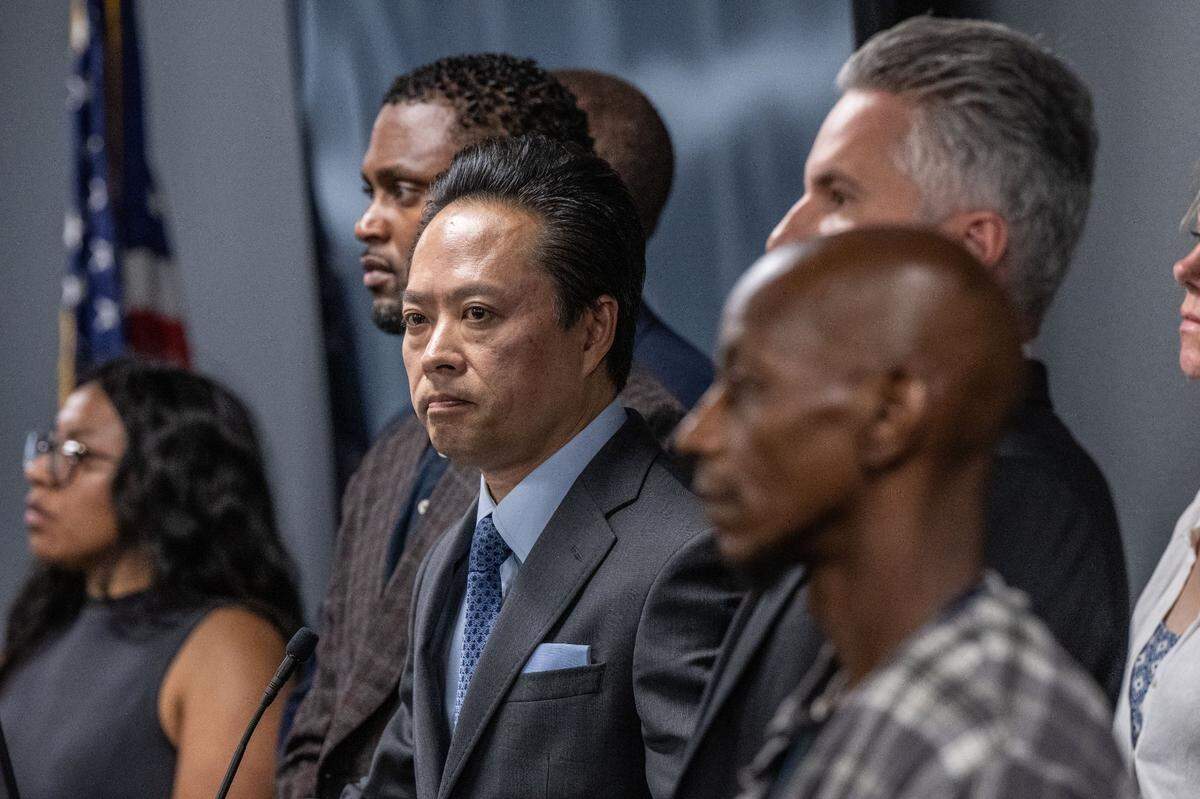 Sacramento County District Attorney Thien Ho stands Tuesday with supporters and victims of alleged crimes by homeless residents at a press conference announcing that his office is suing the city of Sacramento for creating a public nuisance by failing to take stronger action on homeless camps.