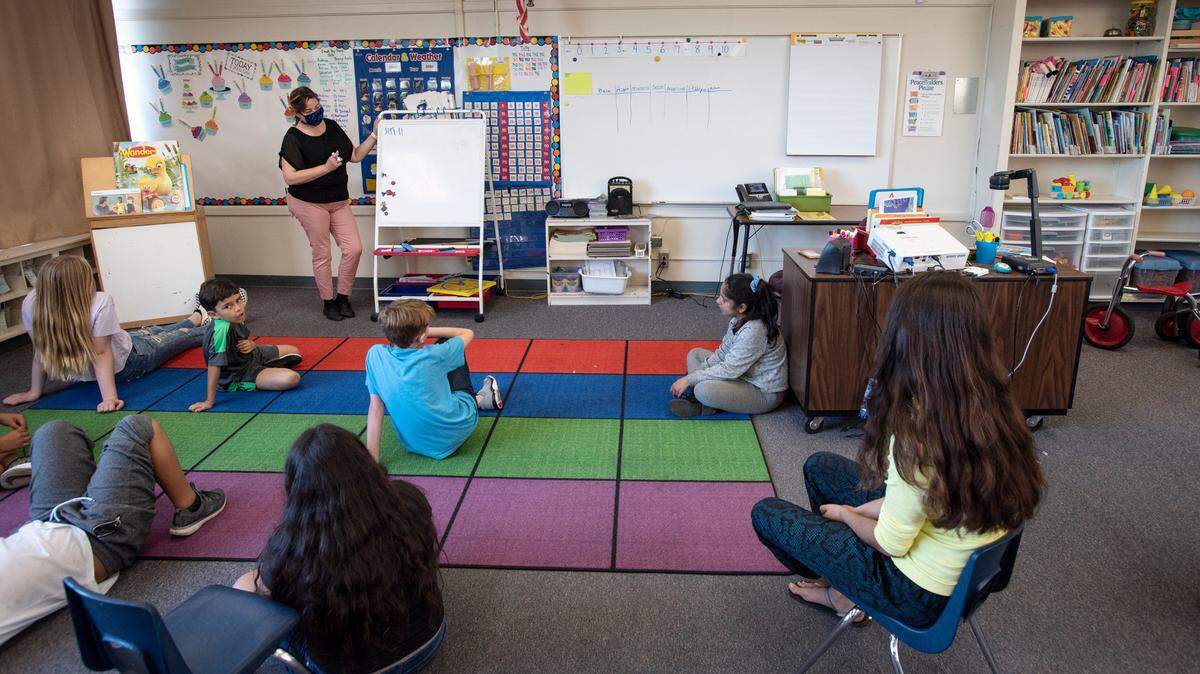 Teacher Evelina Jimenez works with kids during Modesto Schools sponsored child care program at Muir Elementary School in Modesto, Calif., on Wednesday, April 15, 2020.