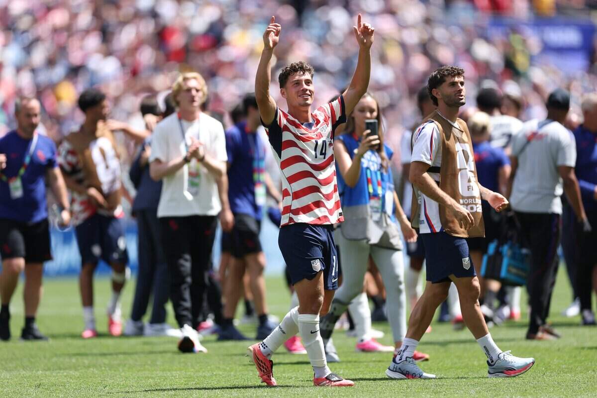 Sebastian Berhalter (14) and Christian Pulisic (10) of the United States applaud fans after the team's 2-0 victory in the FIFA World Cup 2026 Group D match between USA and Australia at Seattle Stadium on Friday in Seattle.