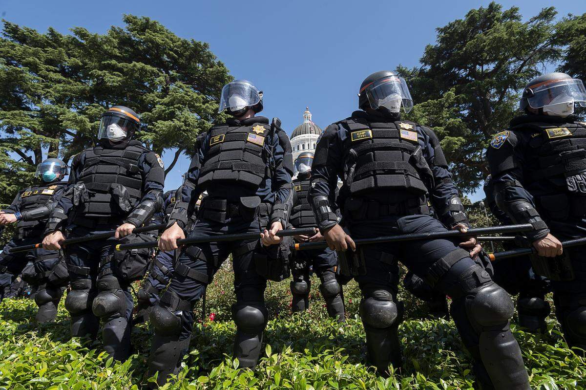 The California Highway Patrol officers block access to the Capitol grounds for protesters of Gov. Gavin Newsoms stay-at-home order on Friday, May 1, 2020, in Sacramento.