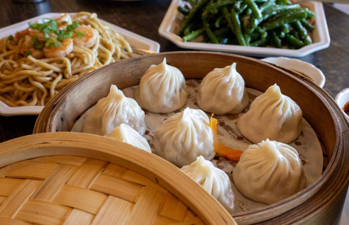 Xiaolongbao soup dumplings filled with crab, garlic noodle shrimp and garlic green beans at Journey to the Dumpling on Tuesday, Oct. 15, 2024, in Elk Grove. 