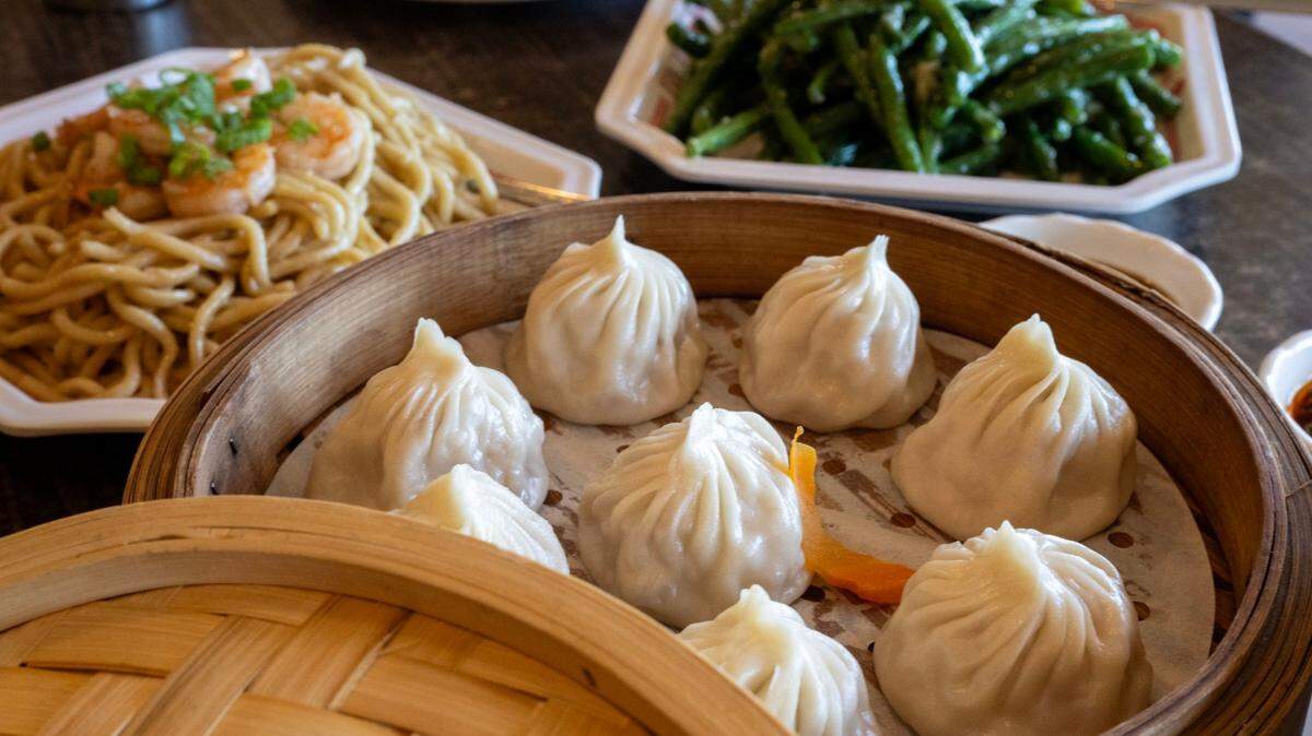 Xiaolongbao soup dumplings filled with crab, garlic noodle shrimp and garlic green beans at Journey to the Dumpling. Its midtown Sacramento restaurant has closed indefinitely following a fire on Thanksgiving.