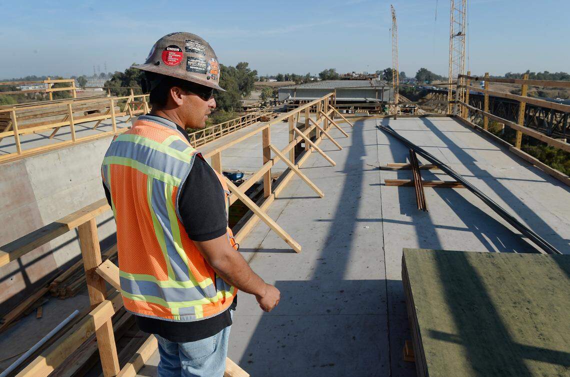 Construction foreman Elmer Garcia walks along the deck of a bridge that will stretch across the San Joaquin River for the California high-speed rail near Highway 99 and Union Pacific railway on the boarder between Madera and Fresno Counties in this drone image made on October 31, 2018.
