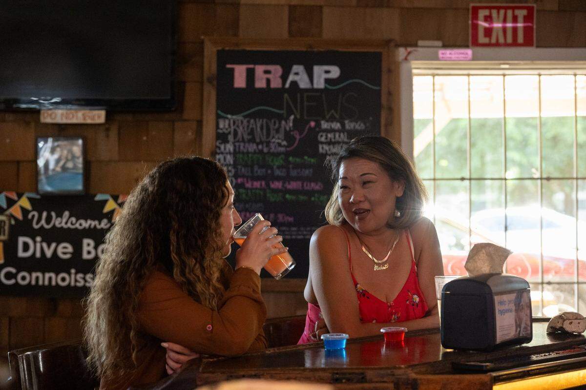 Christina Carta and Rebekah Deborde share company and drinks at The Trap in Sacramento on Monday, July 7, 2025.