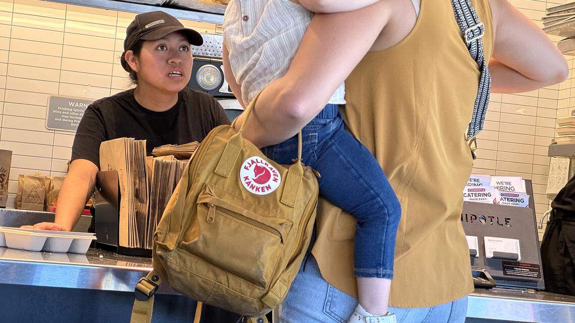 SAN RAFAEL, CALIFORNIA - APRIL 01: A worker helps a customer at a Chipotle restaurant on April 01, 2024 in San Rafael, California. A new minimum wage law went into effect in California today that calls for fast food restaurants with at least 60 locations nationwide to pay employees a minimum of $20 per hour at their stores in California. (Photo by Justin Sullivan/Getty Images)