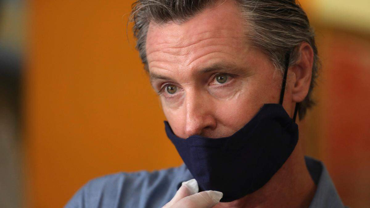 California Gov. Gavin Newsom is interviewed while visiting the Hot and Cool Cafe in Leimert Park in Los Angeles on Wednesday, June 3, 2020. (Genaro Molina/Los Angeles Times via AP, Pool)