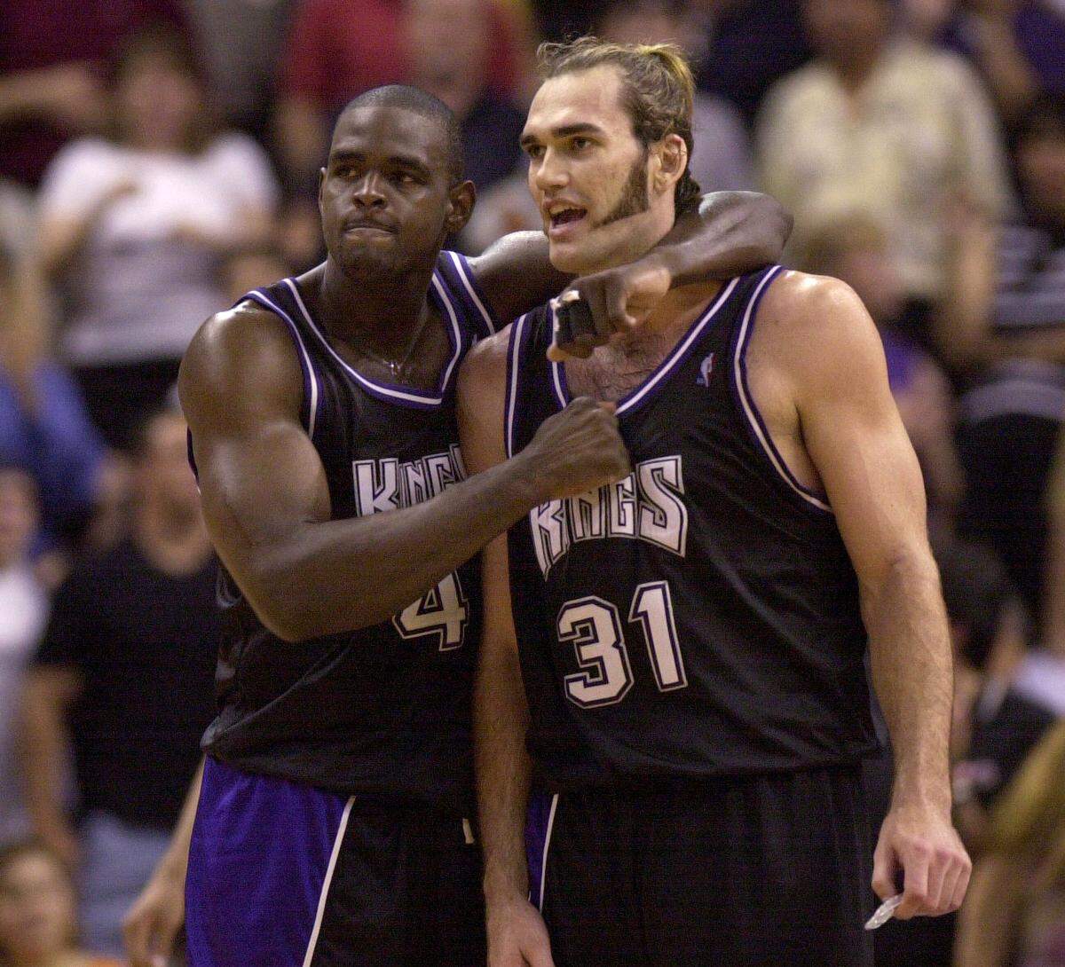 Chris Webber gives Sacramento Kings teammate Scot Pollard a thump on the chest as team secured a Game 4 first-round win over the Phoenix Suns on May 2, 2001.