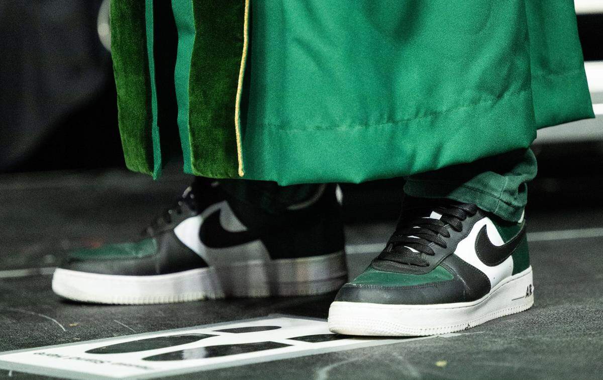 Sacramento State President Luke Wood stands on his spot wearing his signature sneakers during the commencement ceremony at Golden 1 Center on Friday.