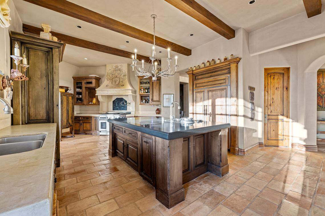 The gourmet kitchen showcases hand-stained cabinetry by a San Francisco artisan, a black granite island, and imported tile, creating a chef’s dream space. Every room in the house, including two offices and a game room, has private outdoor access — perfect for both family life and lavish entertaining.