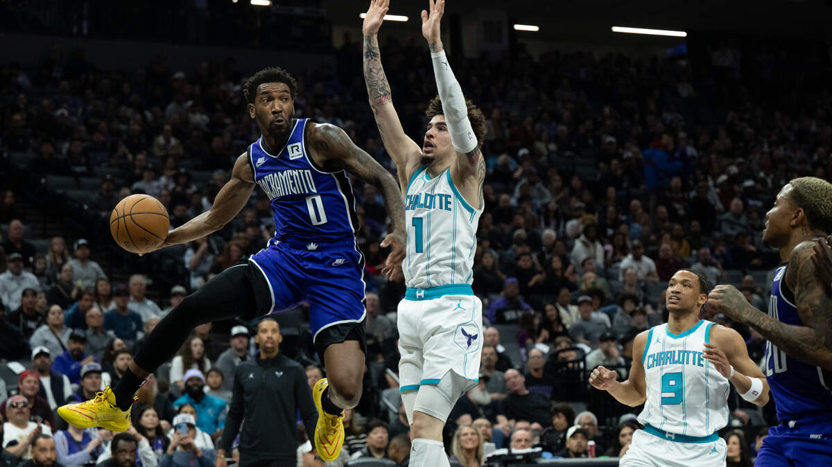 Sacramento Kings guard Malik Monk (0) passes the ball around Charlotte Hornets guard LaMelo Ball (1) at Golden 1 Center on Feb. 24. Monk will miss Wednesday’s game against the Nuggets in Denver due to a toe injury.