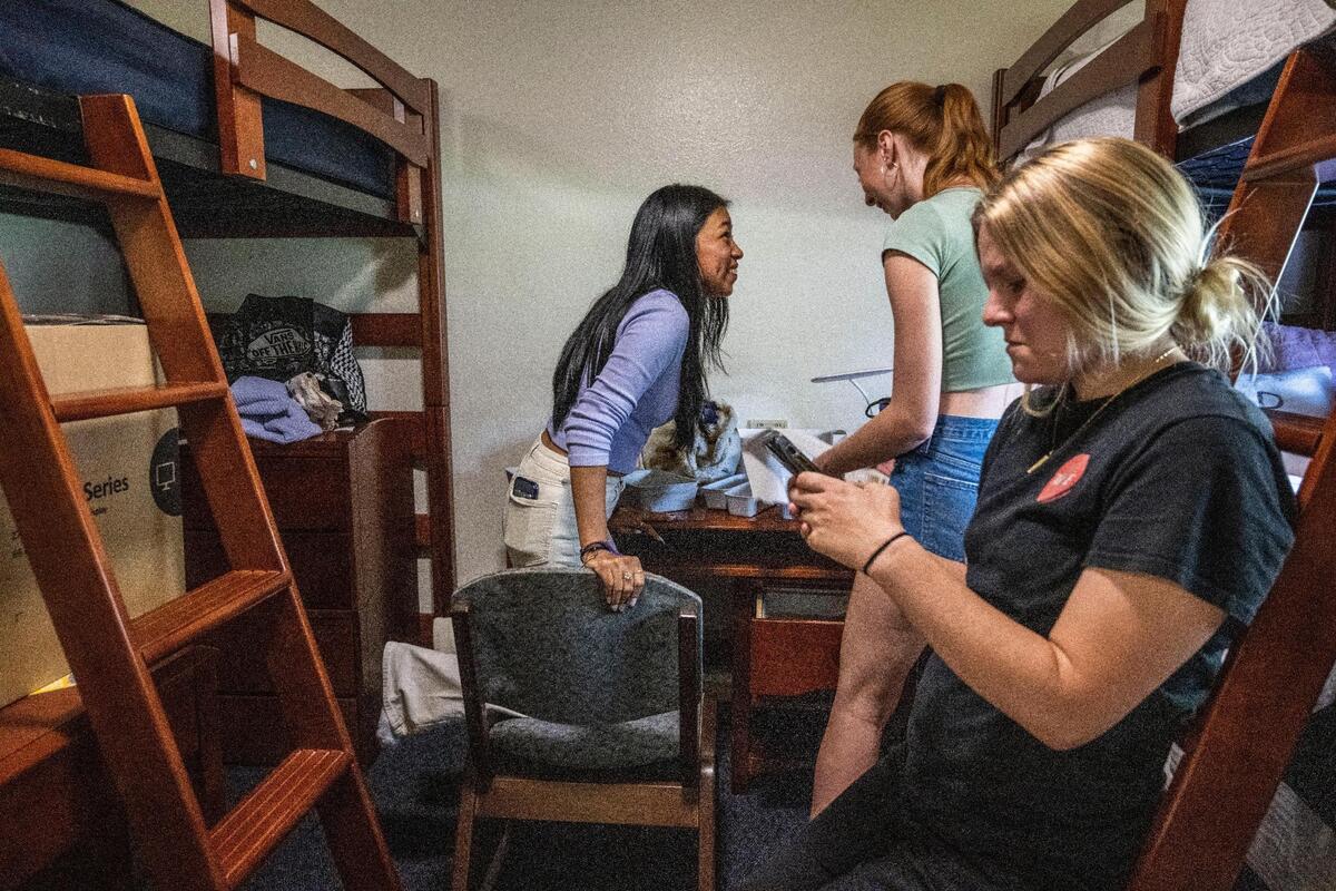 Louisa Maldonado, left, of San Rafael, helps her new roommate Jessica Yandell, of Redondo Beach, organize her desk on Tuesday as roommate Anna Watson, right, of Martinez, checks her phone during move-in day at Sonoma State .
